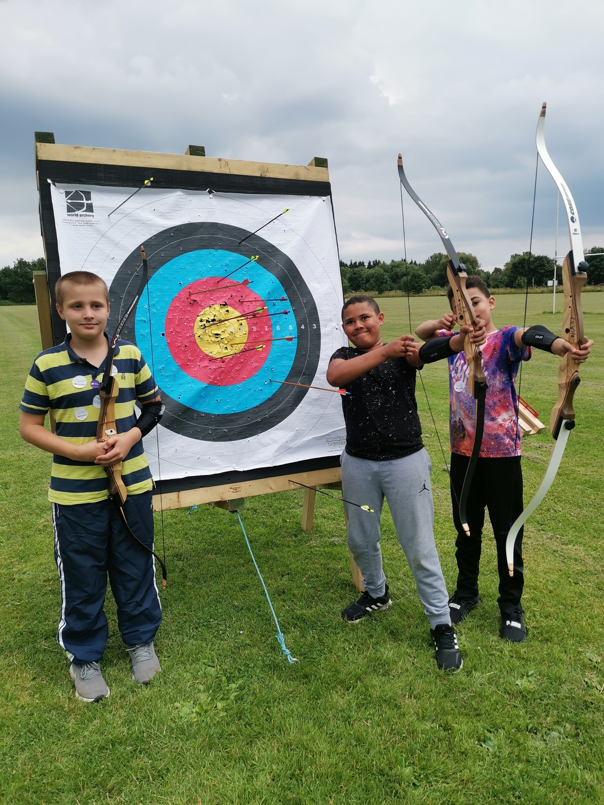 Young archers standing by archery target
